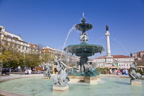 Portugal, Estremadura, Lisbon, Baixa, Praca Rossio with fountain and Statue of King Pedro IV in the centre of the square.