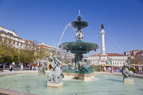 Portugal, Estremadura, Lisbon, Baixa, Praca Rossio with fountain and Statue of King Pedro IV in the centre of the square.