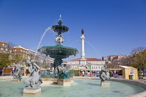 Portugal, Estremadura, Lisbon, Baixa, Praca Rossio with fountain and Statue of King Pedro IV in the centre of the square.