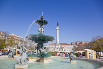 Portugal, Estremadura, Lisbon, Baixa, Praca Rossio with fountain and Statue of King Pedro IV in the centre of the square.