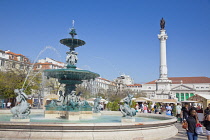 Portugal, Estremadura, Lisbon, Baixa, Praca Rossio with fountain and Statue of King Pedro IV in the centre of the square.