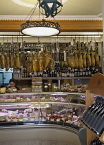Portugal, Estredmadura, Lisbon, Baixa, Interior of delicatessen with hanging Presunto hams