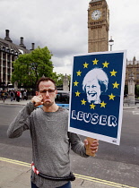 Law & Order, Frech protester in Westminster holding anti Theresa May poster 2017, London, England.