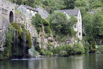 France, Lozere 48, St Chely du Tarn, Waterfall and village buildings in the Gorges du Tarn.