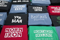 Ireland, North, Belfast, St George's Market interior, Display of clothing on sale.