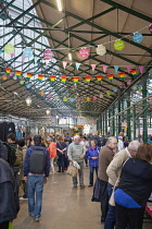 Ireland, North, Belfast, St George's Market interior busy with people shopping.