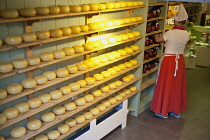 Holland, North, Amsterdam, Cheese shop worker in traditional Dutch costume.