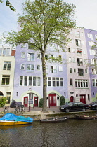 Holland, North, Amsterdam, Colourful modern canalside buildings.