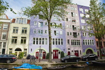 Holland, North, Amsterdam, Colourful modern canalside buildings.