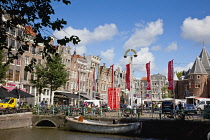 Holland, North, Amsterdam, Boat moored next to the old city gate De Waag in the Nieuwmarkt neighbourhood.