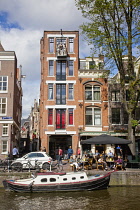 Holland, North, Amsterdam, Boat moored outside typical gable building with three statues on balcony.