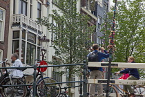 Holland, North, Amsterdam, Padlocks with declarations of love stuck on lifting bridge.