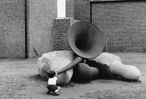 England, Merseyside, Liverpool, Young boy trying to blow old fog horn.