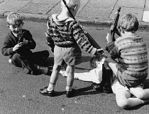 England, Merseyside, Bootle, Young children playing in Blossom street with toy guns.