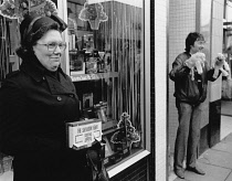 England, Merseyside, Southport, Woman collecting for the Salvation Army at Christmas time in 1987.