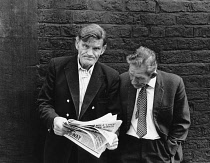 England, Merseyside, Liverpool, Two men reading the Daily Mirror newspaper in the street, 1968.