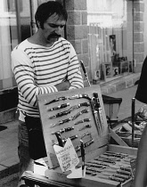 France, Brittany, La Roche Bernard, Knife vendor in open market, 1987.