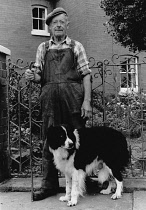 Wales, Powys, Llanymynech, Portrait of Welsh farmer with his dog.