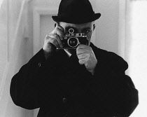 Self portrait of the photographer using film camera.