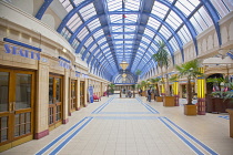 England, Lancashire, Blackpool, Winter Gardens interior with tiled floor, glass roof and palm trees.