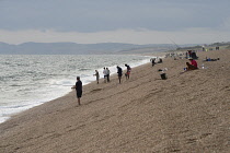 England, Dorset, Portland, Chesil Beach, Anglers fishing from the pebble beach.