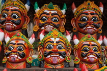 India, Pondicherry, Display of masks of an evil god at an arts and crafts stall in market.