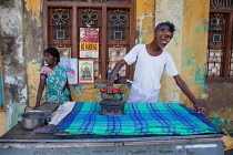 India, Pondicherry, Man ironing linen in Pondicherry.