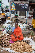 India, Tamil Nadu, Chidambaram, Peanut & yam vendor in the market at Chidambaram.