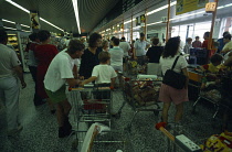 England, Shopping, Groceries, Kids in trolley at checkout.