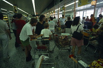 England, Shopping, Groceries, Kids in trolley at checkout.