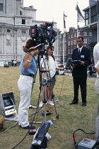 Media, News reporter and television camera crew.