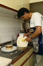 Cleaning, Man washing dishes kitchen sink.