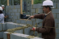 Construction,  Bricklayer building house.