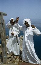 Qatar, Local fishermen on board their dhow checking lines for fish caught.