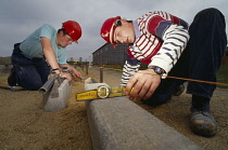 Construction, Worker using spirit level.