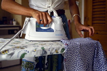 Cleaning, Household, Laundry, Close up of woman ironing clothing.