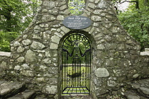 Wales, Caernarfonshire, Llanystumdwy, Monument for David Lloyd Georgewith stone surround and ornamental iron gate.