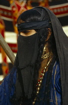 Qatar, General, Portrait of veiled Bedouin woman.