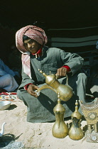 Qatar, General, Bedouin youth pouring coffee.