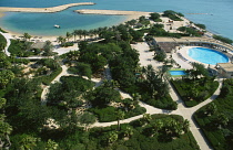 Qatar, Doha, Aerial view over the Sheraton Hotel swimming pool and beach.