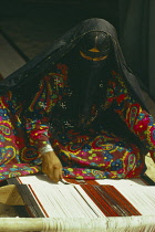 Qatar, Desert, Bedouin woman weaving fabric.