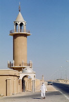 Qatar, Al Wakrah, Man walking past Mosque