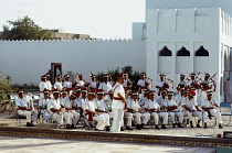 Qatar, Doha, Exterior of Museum with military band including bagpipers playing at opening.
