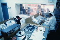 Qatar, Media, Men working in television control suite.