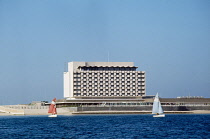 Qatar, Doha, Gulf Hotel with sailing dingies in the foreground.