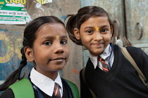 India, Uttar Pradesh, Varanasi, Portrait of two school girls with tika marks.