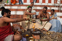 India, Uttar Pradesh, Varanasi, A pundit performs a puja for a bereaved family at Kedar Ghat.