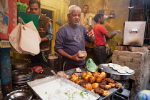 India, Uttar Pradesh, Varanasi, A food hotel serving idlis & dahl vada in the old city.