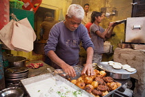 India, Uttar Pradesh, Varanasi, A food hotel serving idlis & dahl vada in the old city.