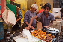 India, Uttar Pradesh, Varanasi, A food hotel serving idlis & dahl vada in the old city.